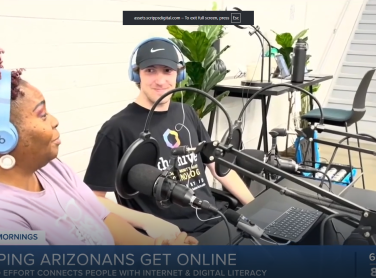 A woman is explaining to a digital navigator about her podcasting experience at the Tempe Hive